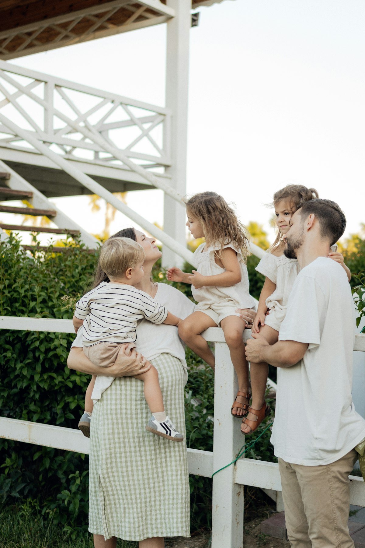A family together on their front porch in the evening light